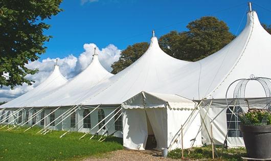 a group of luxury portable restrooms with individual stalls and running water in Bailey